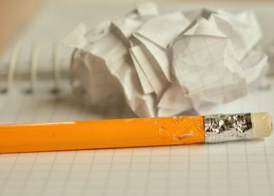 Stift mit Block und zerknülltem Papier